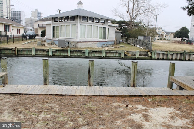 dock area featuring a water view and central air condition unit