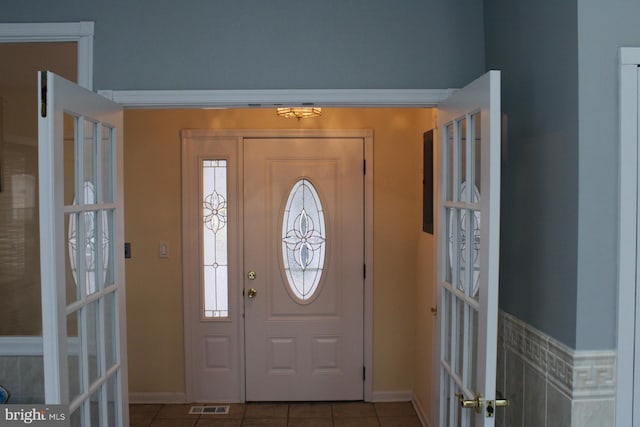 foyer entrance with tile patterned flooring