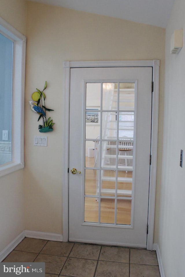 doorway to outside featuring light tile patterned floors