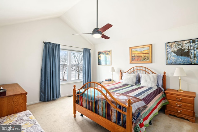 bedroom with ceiling fan, vaulted ceiling, and light carpet