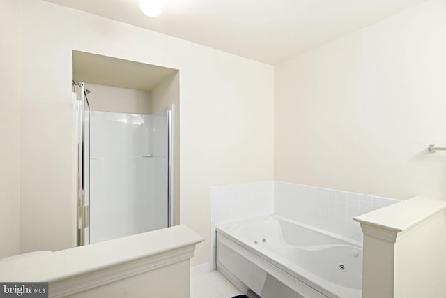 bathroom featuring tile patterned flooring and shower with separate bathtub