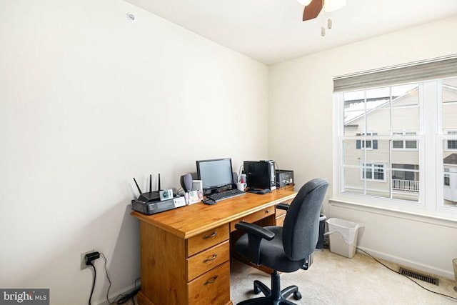 carpeted office featuring ceiling fan