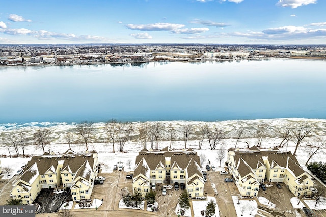 snowy aerial view featuring a water view