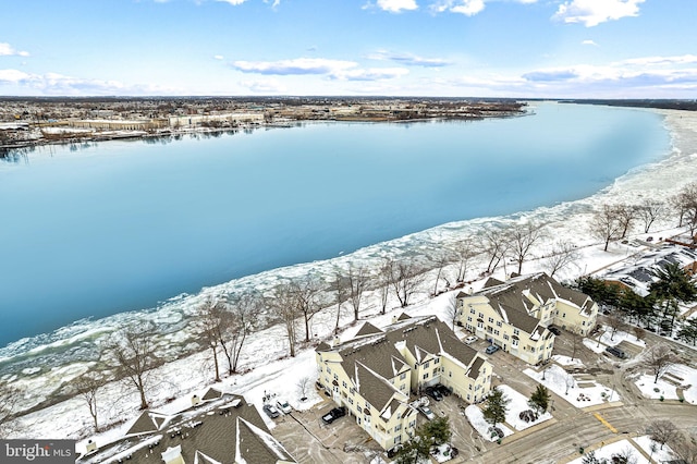 snowy aerial view with a water view