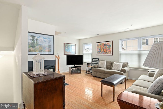 living room with a wealth of natural light and light wood-type flooring