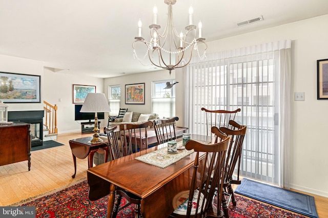 dining room with a notable chandelier and light wood-type flooring