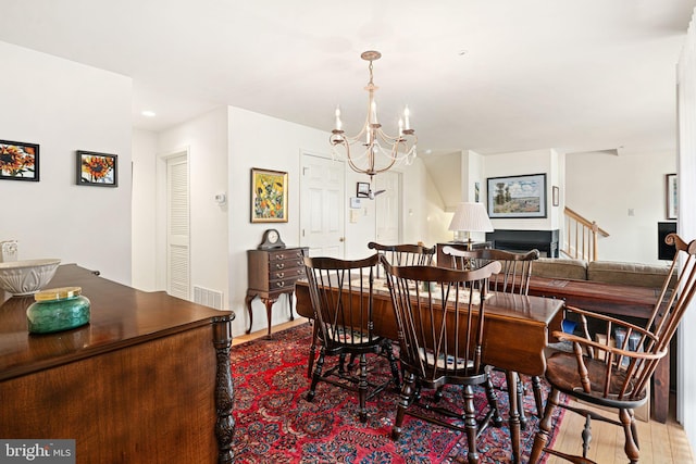 dining space with an inviting chandelier and hardwood / wood-style floors