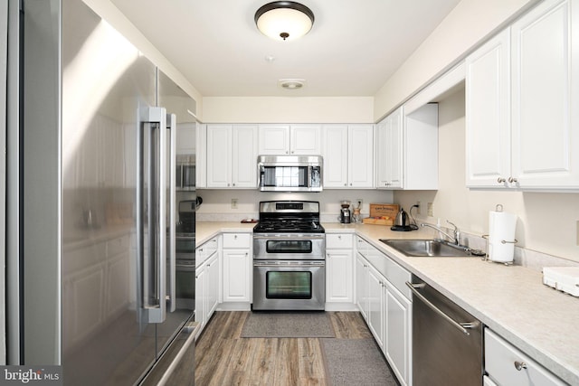 kitchen with white cabinets and appliances with stainless steel finishes