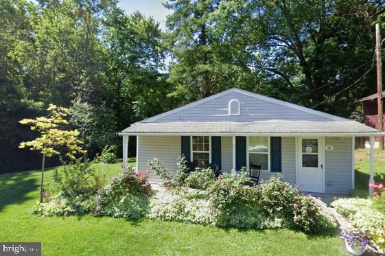 exterior space with a porch and a yard