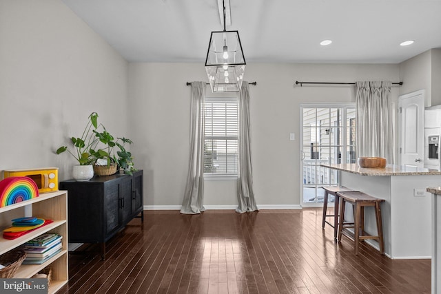 dining area featuring dark wood-type flooring