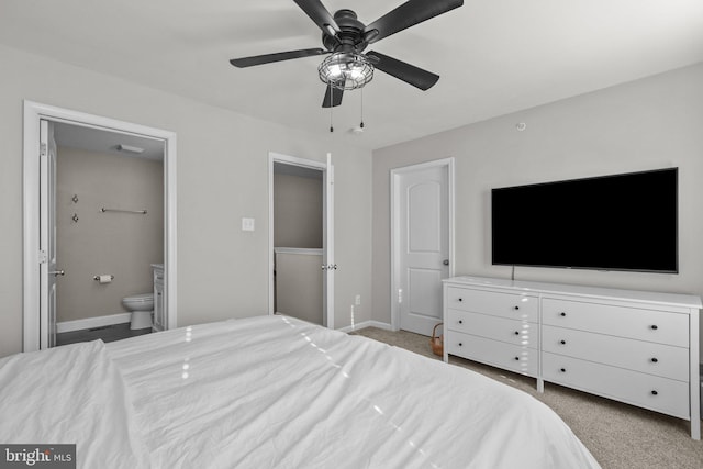 carpeted bedroom with ceiling fan and connected bathroom