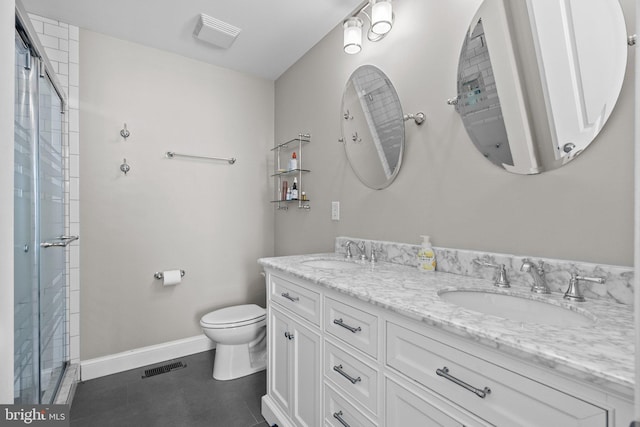 bathroom with toilet, vanity, and walk in shower