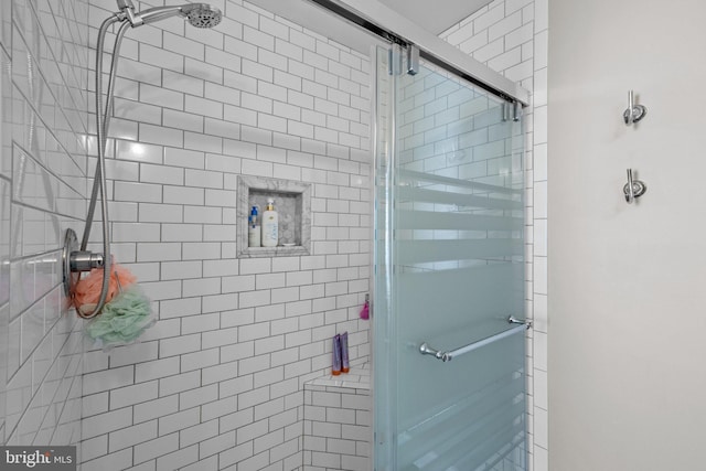 bathroom featuring a shower with door