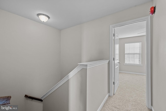 hallway featuring light colored carpet