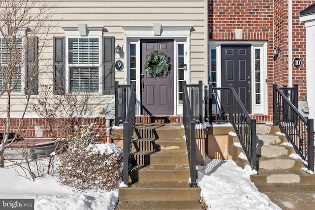 view of snow covered property entrance