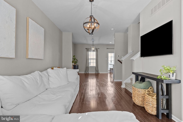 living room featuring dark hardwood / wood-style floors and a notable chandelier