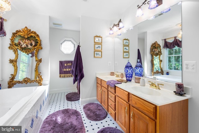 bathroom with tiled bath and vanity