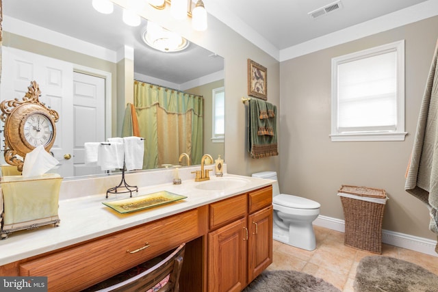 bathroom featuring toilet, a healthy amount of sunlight, tile patterned floors, and vanity