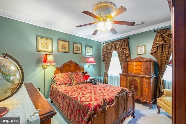 carpeted bedroom with ceiling fan and crown molding