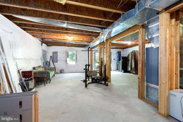 basement with electric panel and washer / clothes dryer