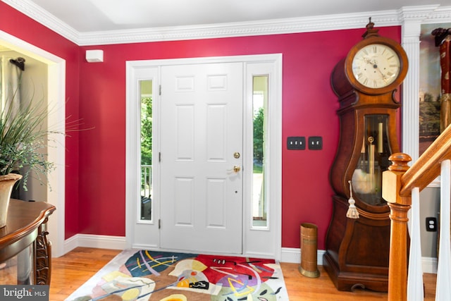 entryway with light wood-type flooring and ornamental molding