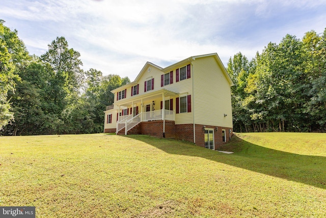 view of front facade with a front yard and a porch