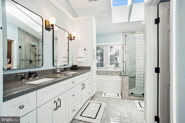 bathroom with vanity, a wealth of natural light, and separate shower and tub