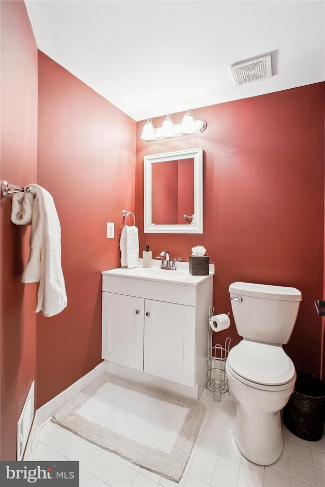 bathroom featuring tile patterned floors, vanity, and toilet