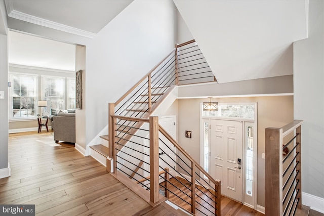 entryway with crown molding and hardwood / wood-style flooring