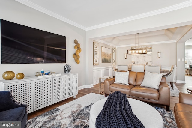 living room with ornamental molding, dark wood-type flooring, and an inviting chandelier