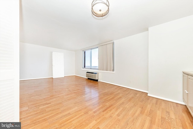 interior space with light hardwood / wood-style floors and heating unit