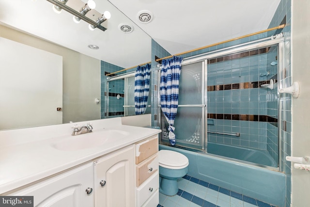 full bathroom featuring toilet, vanity, tile patterned floors, and shower / bathtub combination with curtain