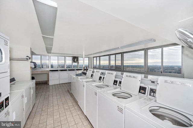 laundry area with light tile patterned flooring, washer and dryer, and stacked washer / dryer