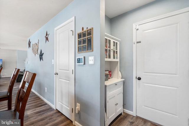 corridor with dark wood-type flooring