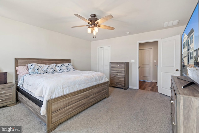 bedroom featuring ceiling fan, carpet flooring, and a closet