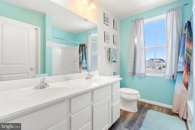 full bathroom with shower / bath combo with shower curtain, wood-type flooring, toilet, and vanity