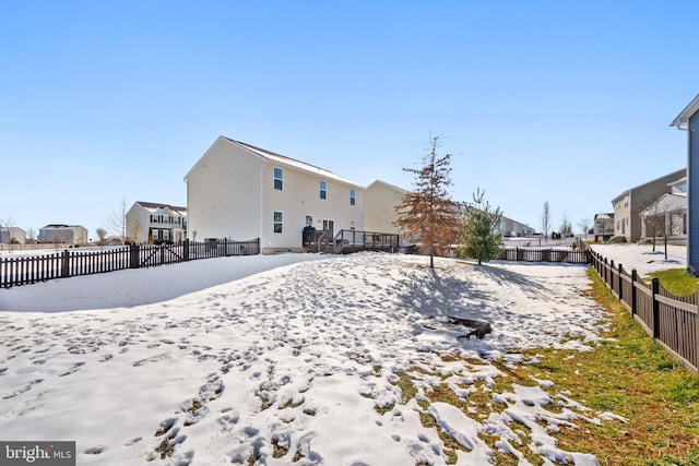 view of snow covered rear of property