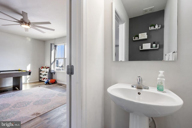 bathroom with ceiling fan, sink, pool table, and hardwood / wood-style flooring