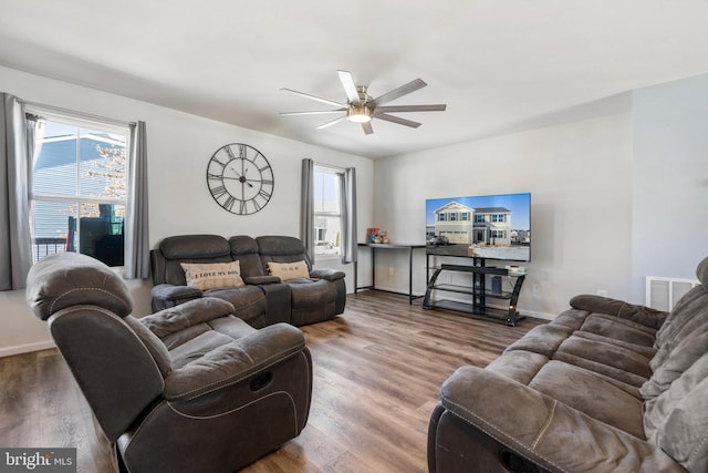 living room featuring hardwood / wood-style flooring and ceiling fan