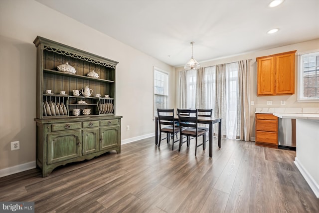 dining space with dark hardwood / wood-style flooring