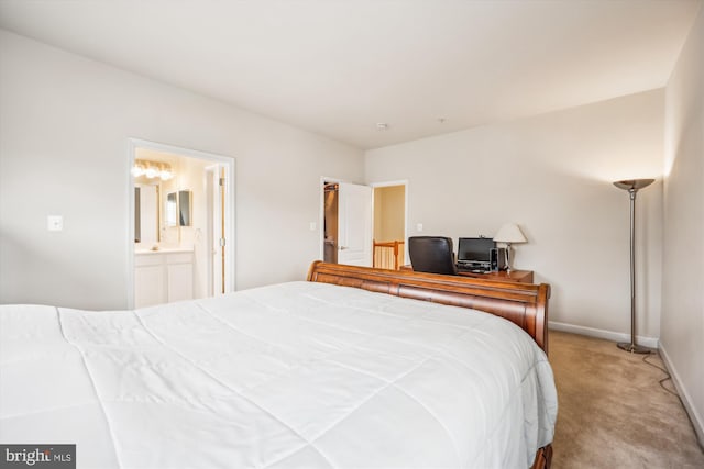 bedroom featuring light carpet and ensuite bath