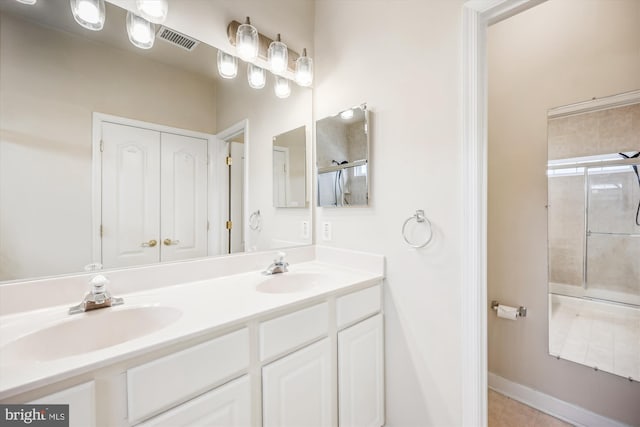 bathroom featuring vanity, tile patterned floors, and a shower with door