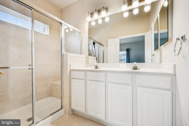 bathroom featuring tile patterned floors, walk in shower, and a healthy amount of sunlight