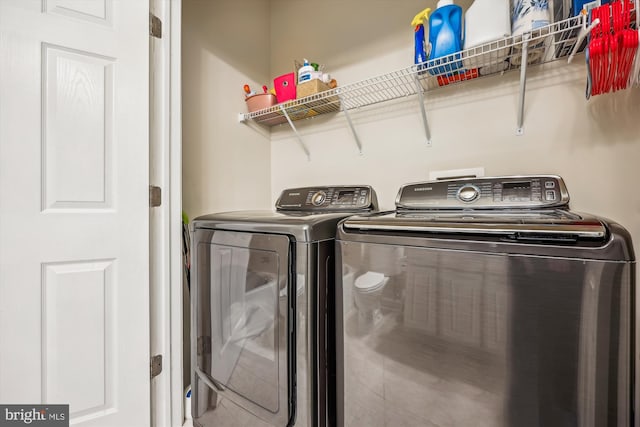 washroom featuring washing machine and dryer