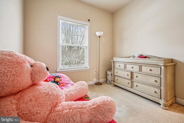 living area featuring a wealth of natural light and light colored carpet