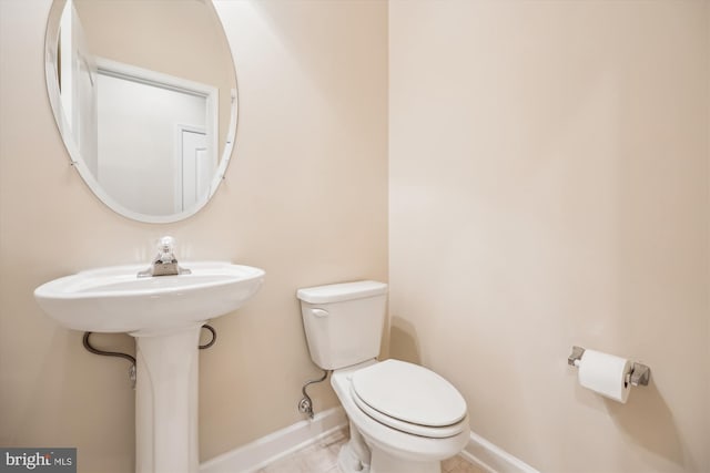 bathroom with toilet and tile patterned floors