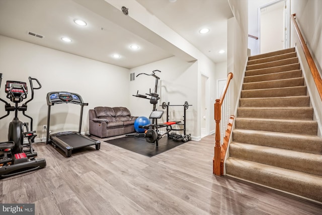 workout area with hardwood / wood-style flooring