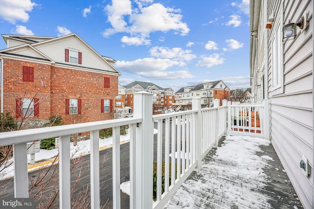 view of snow covered back of property