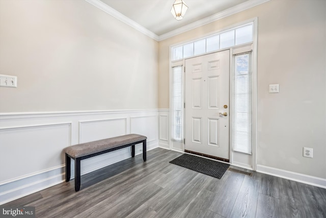 entryway with dark hardwood / wood-style flooring and crown molding