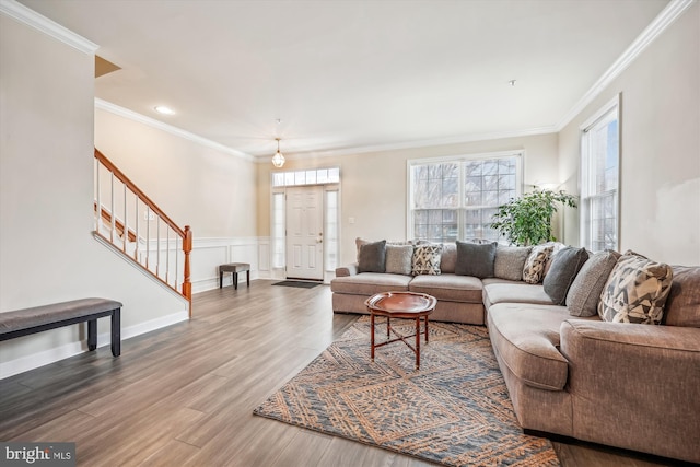 living room featuring wood-type flooring and crown molding